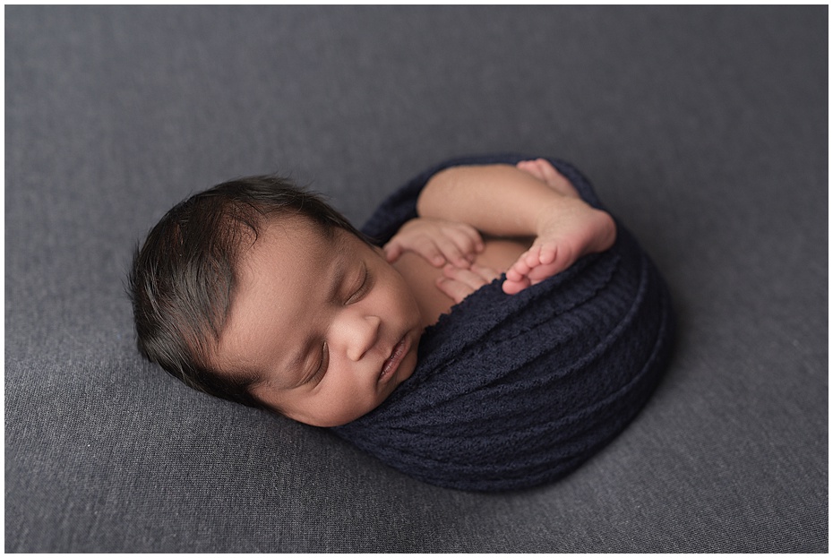 curled-back sleeping-blue-newborn