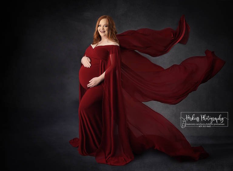 Pregnant with newborn boy in red dress