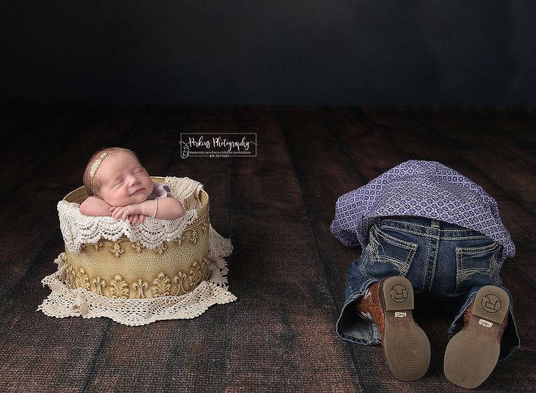sibling acting out during newborn sister photo shoot